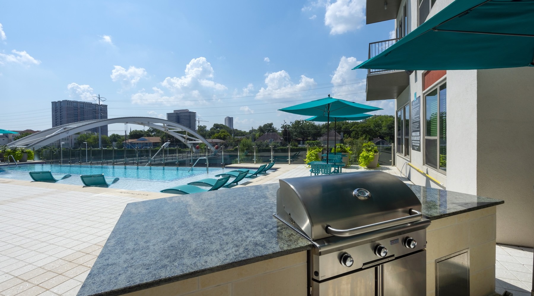 a pool with a grill in front of it