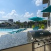 a pool with a grill in front of it