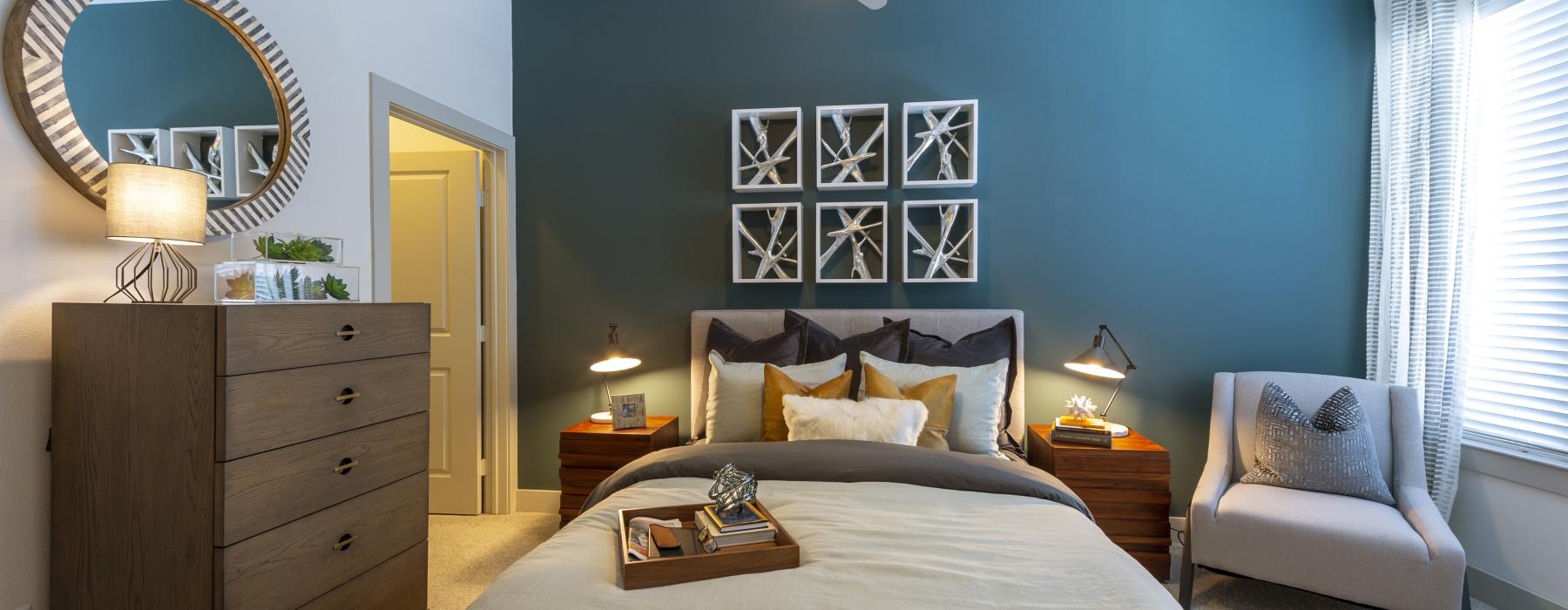 a bedroom with a bed and a mirror