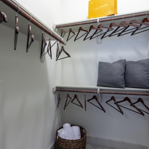 a closet with a basket and shelves